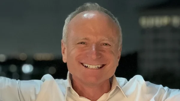 Chiropractor Palm Beach Gardens FL Mitch Siegal A photo of Dr. Mitch Siegal wearing a white collared shirt and smiling brightly